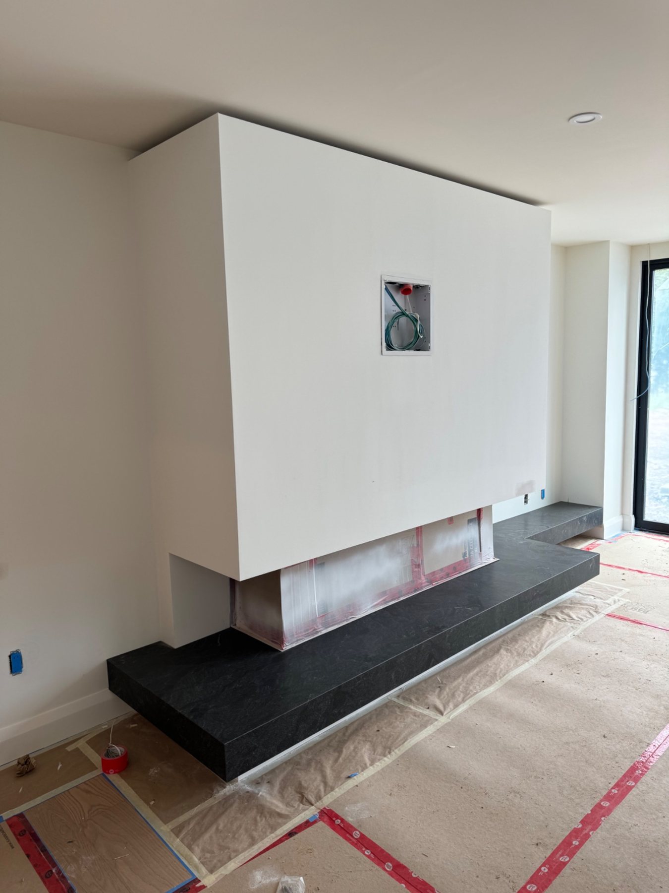 Finished custom-home drywall around a modern fireplace