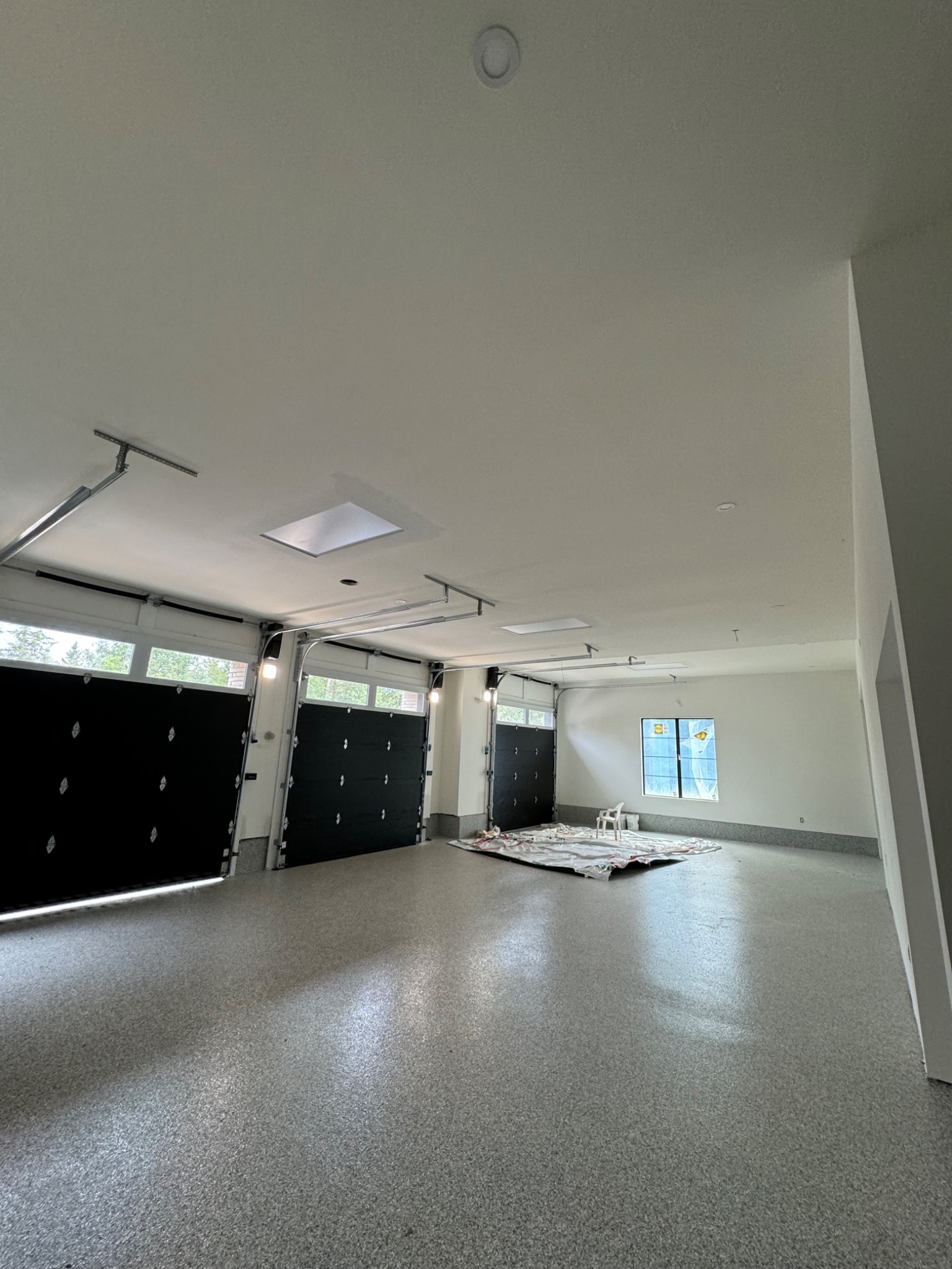 Large finished residential garage with smooth drywall surfaces