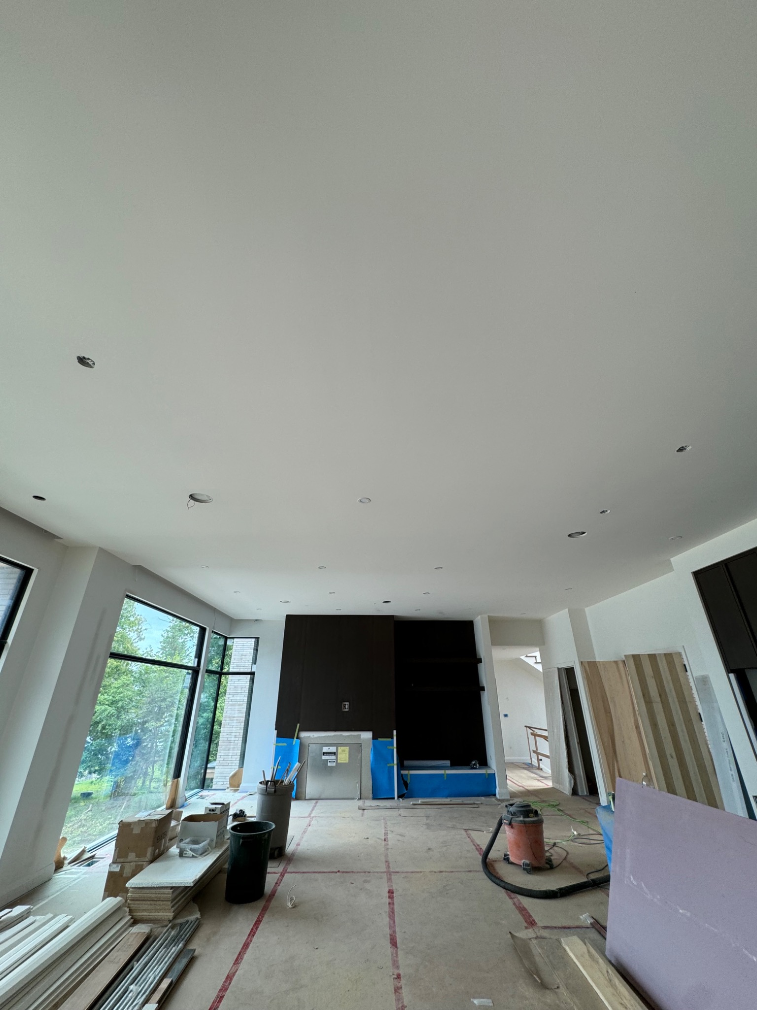 Large finished custom-home great room with smooth ceiling
