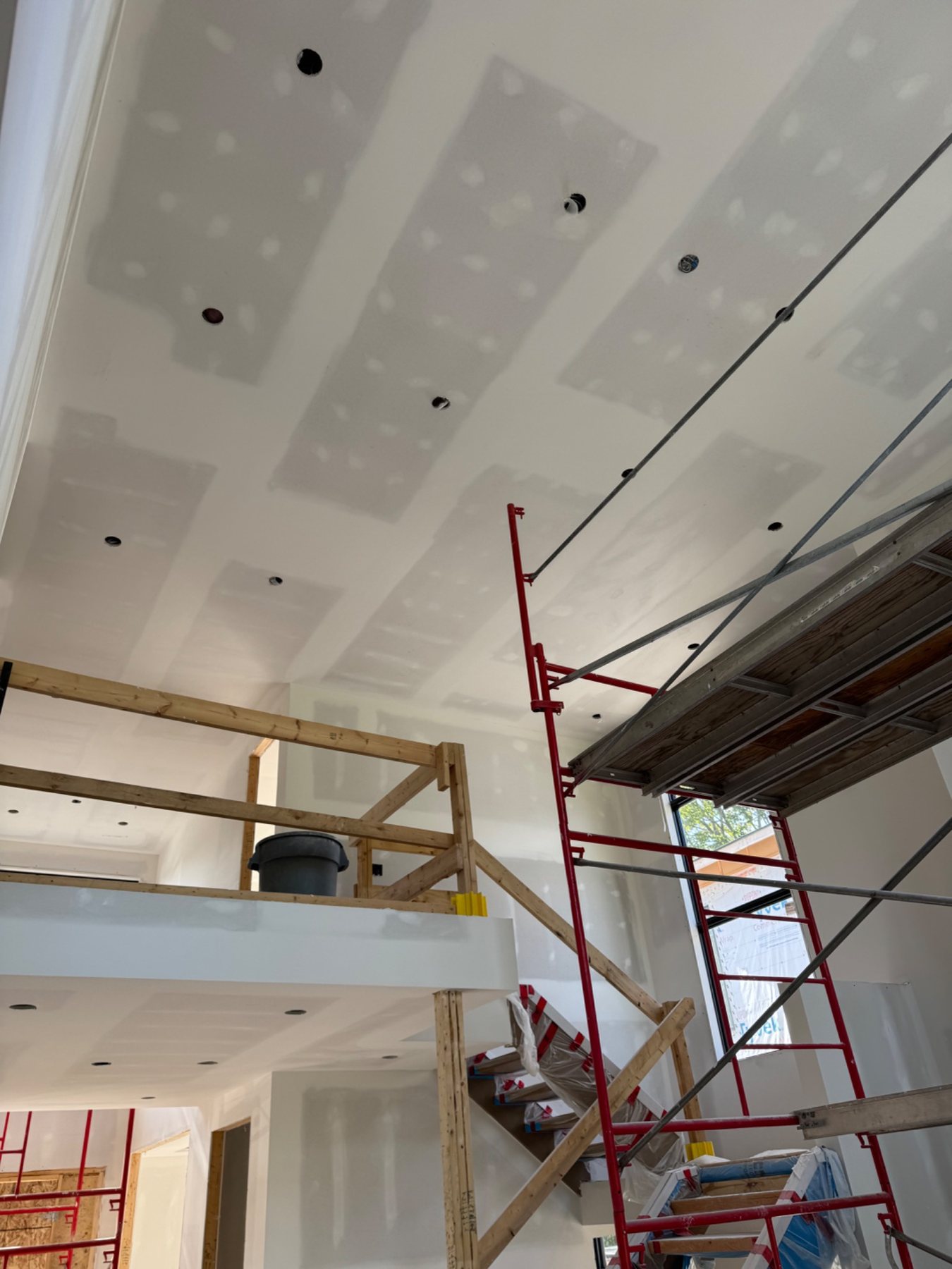 High ceiling and stairwell drywall work in a custom home